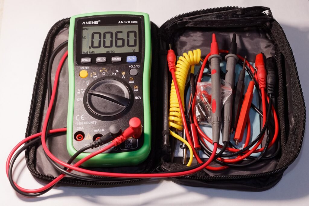 Digital multimeter with test leads in its case