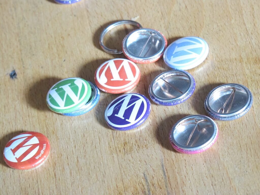 WordPress badges on a wooden table