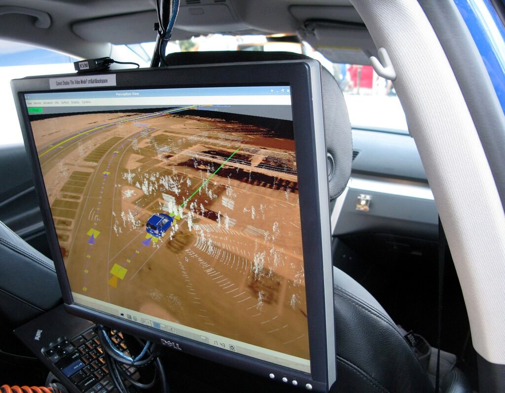 Screen inside a self-driving test car showing the lidar point cloud and the planned path